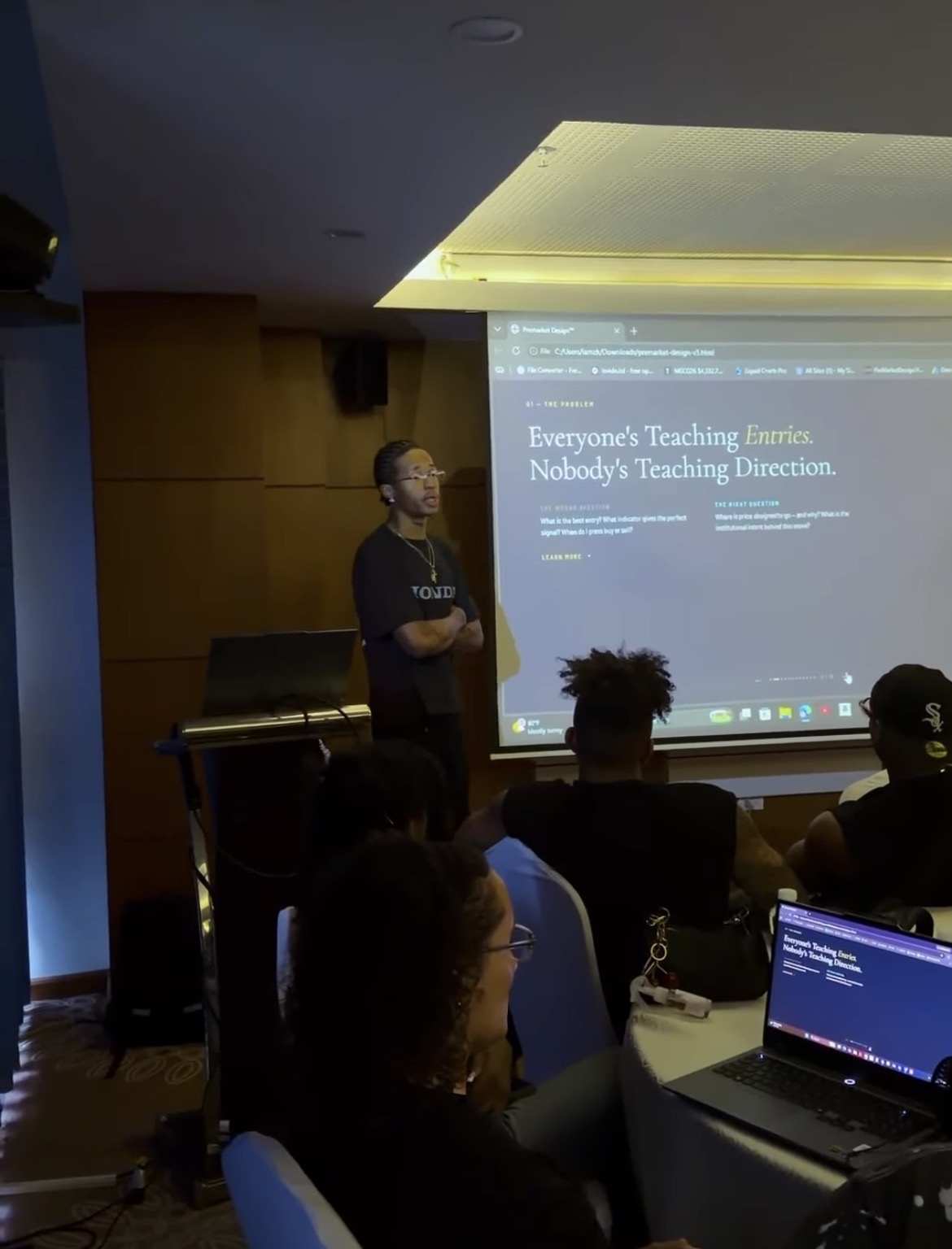 Azekiel speaking to a room of traders